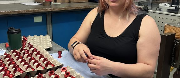 Assembly worker inspecting aluminium anodised parts